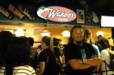 <strong>MICHAEL KARAKASH |</strong> Staff Photographer<br>Wing Lam, Wahoo’s co-founder and co-owner, takes a moment to enjoy the UCI branch opening.