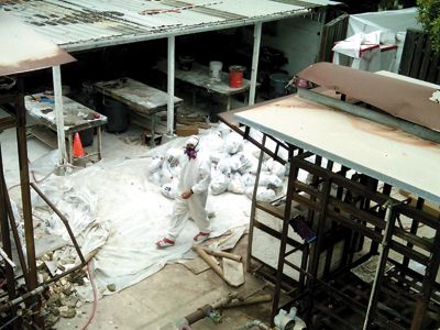 SandeepAbrahamAsbestos courtesy of sandeep abraham A worker from the asbestos clearing company, P.W. Stephens, helps to clear the carcinogen.
