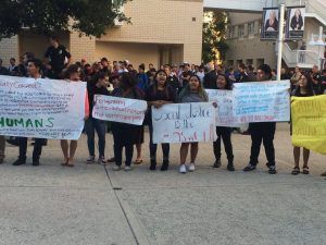 About 30 students protest with signs and chants outside of the barricaded line to Milo Yiannopoulos's "Social Justice is Cancer" event. (Courtesy of Megan Cole)