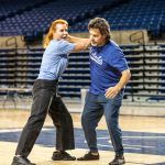 Experts demonstrate self-defense moves.
