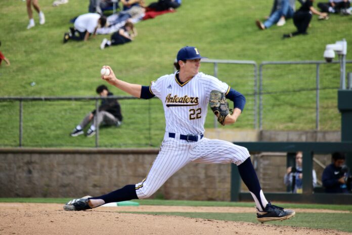 A pitcher in an "Anteaters" uniform throws a pitch