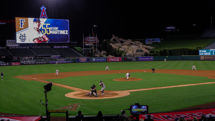 UC Irvine junior first baseman Anthony Martinez awaits a pitch from a Cal State Fullerton Pitcher. The video board with Martinez on it is in the top left corner