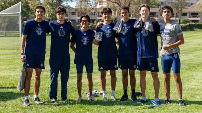 Men's cross country runners pose for a photo at Mason Regional Park in Vanguard Invitational gear